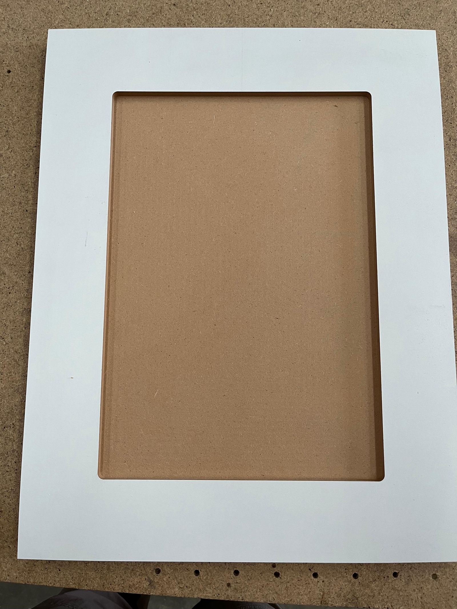 Close-up of a white shaker-style cabinet door frame produced by Oktay Cabinets