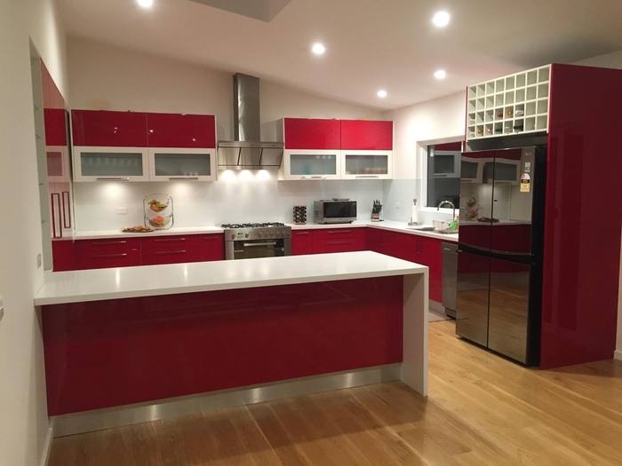 High-gloss red kitchen with white benchtop